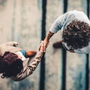 Top view of two people shaking hands.